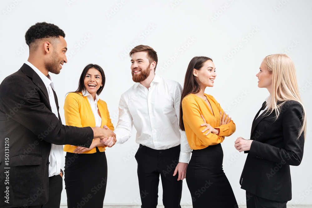 Happy colleagues business team standing in office Happy colleagues business team standing in office