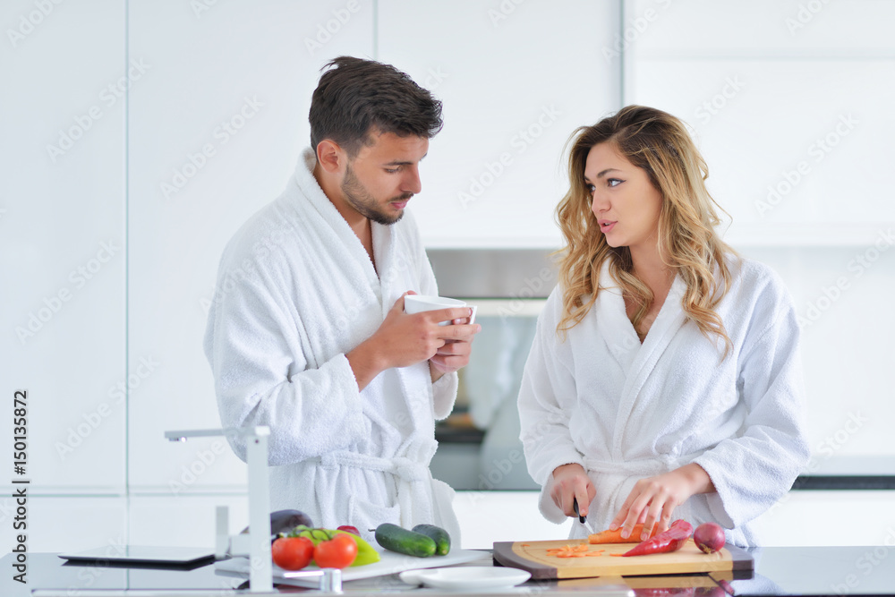 Happy couple cooking breakfast together in the kitchen Happy couple cooking breakfast together in the kitchen