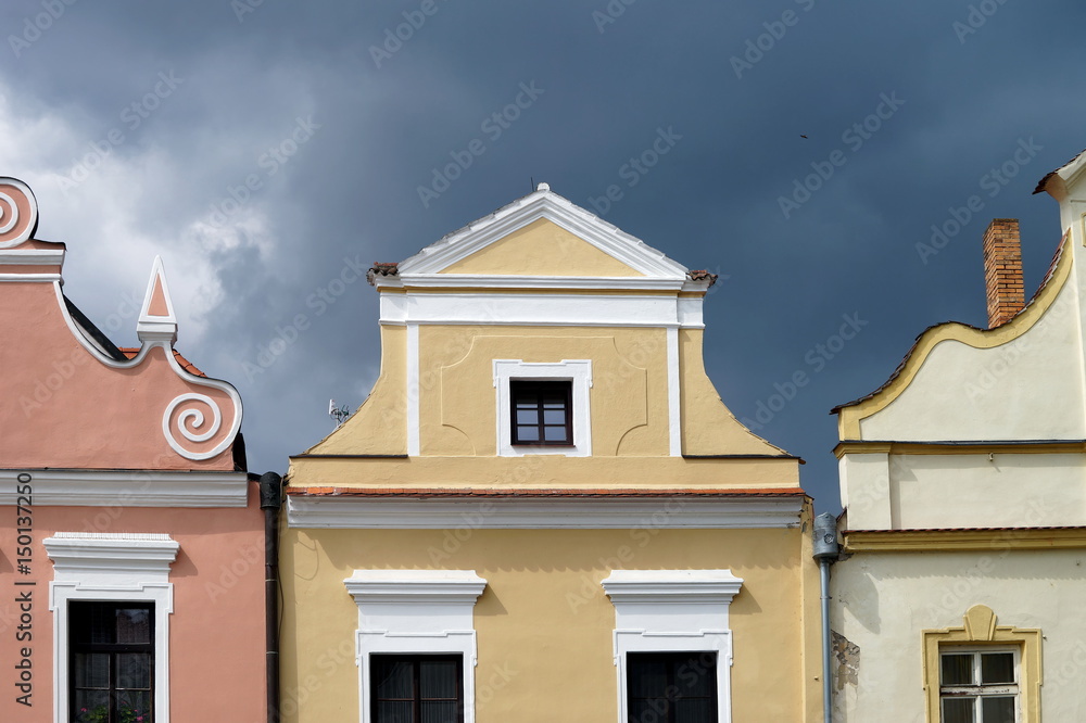 Colourful facade of old houses in Trebon, Czech republic. Dramatic sky at background.