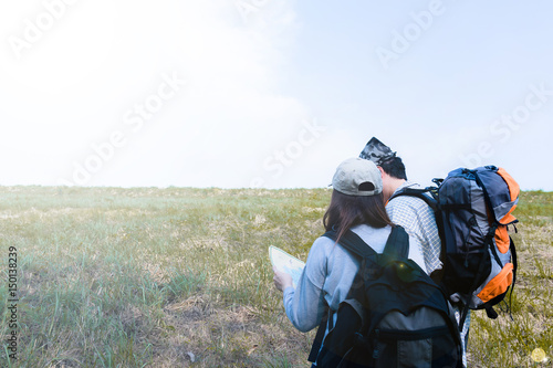Backpacker couple will using map for check hiking travel.