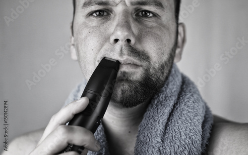 monochrome textured portrait bearded man shaving