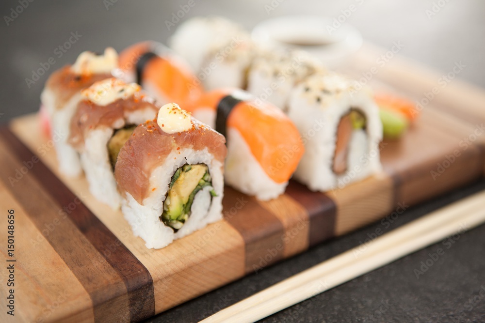Assorted sushi set served on wooden board Assorted sushi set served on wooden board