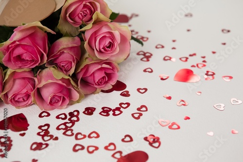 Bunch of pink roses surrounded by heart-shaped decoration