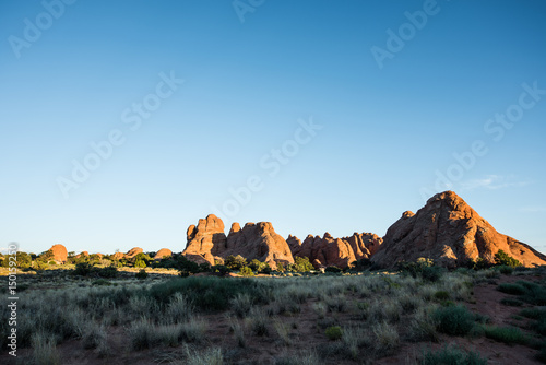 Overlook of red canyons in Arches National Park during sunset