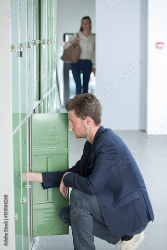 student opening lockers at the university