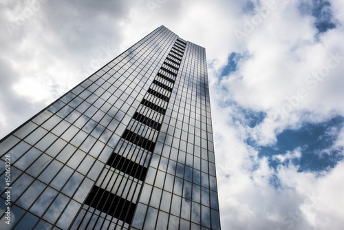 glass high rise building clouds sky reflection