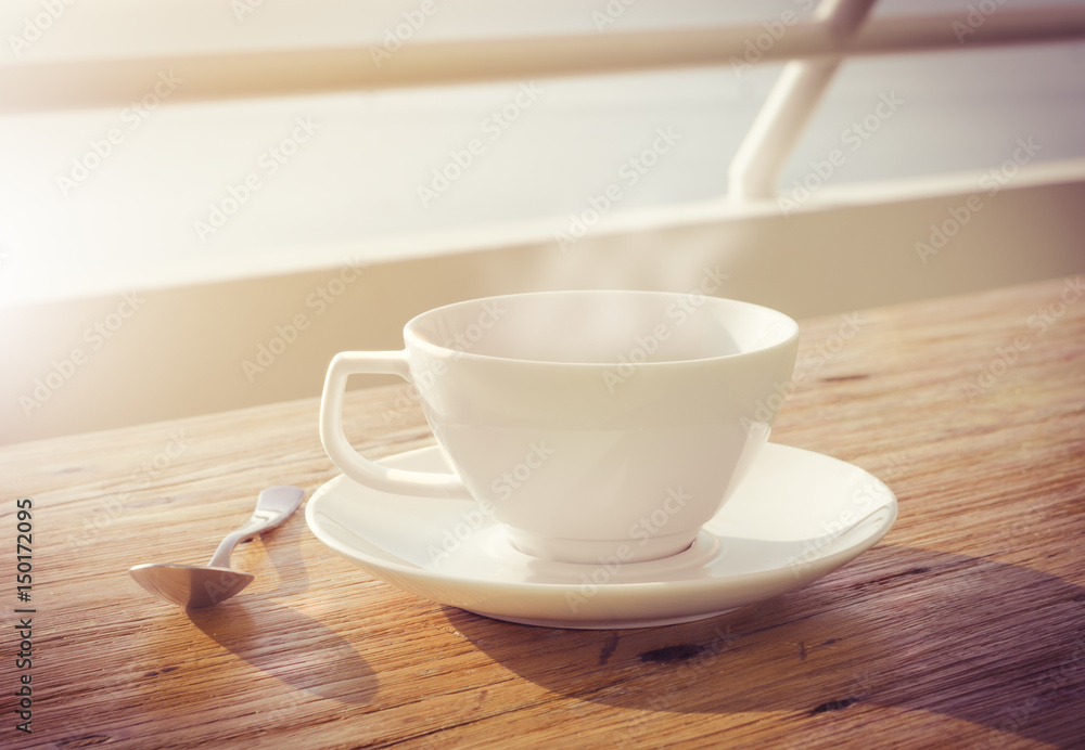 cup of coffee on wooden table with morning sun vintage effect cup of coffee on wooden table with morning sun vintage effect