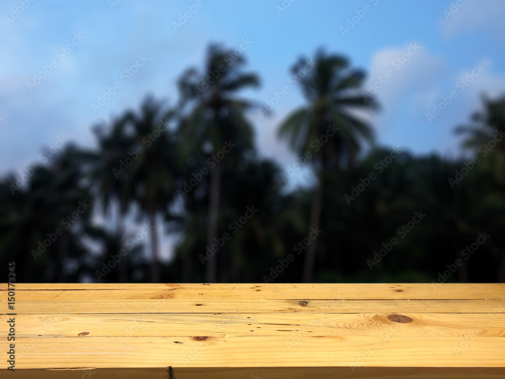 Empty wooden table space platform and blurred Coconut grove background for product display montage. Empty wooden table space platform and blurred Coconut grove background for product display montage.