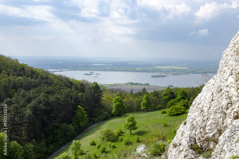 View of the hilly landscape of Palava with forests, rocks in South Moravia under a blue sky with clouds