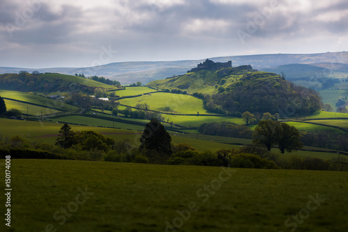 Dramatic Silhouette of Carreg Cennen Castle in the Beautiful Rolling Countryside of Carmarthenshire, Wales, UK photo