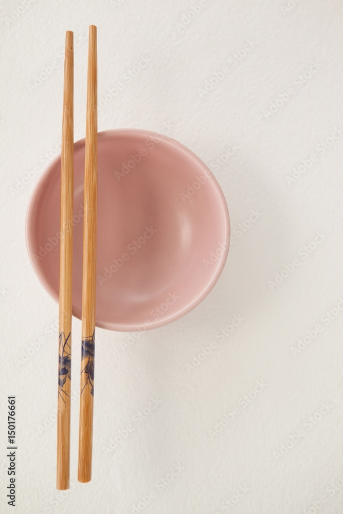 Pair of chopsticks over a bowl Pair of chopsticks over a bowl