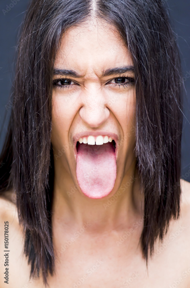 Portrait of a beautiful woman with her tongue out of her mouth Portrait of a beautiful woman with her tongue out of her mouth
