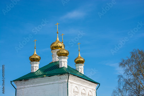 Golden Church domes on the background of blue sky. photo