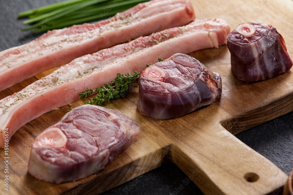 Sirloin chops and beef steak on wooden board