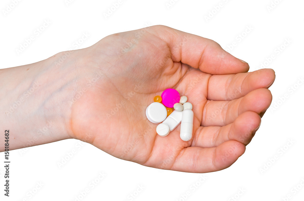 Pile of pills in female hand isolated on white Pile of pills in female hand isolated on white