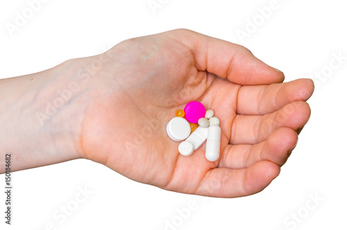 Pile of pills in female hand isolated on white