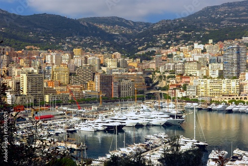 Monaco harbor Port Hercule yachts with mountain backdrop

