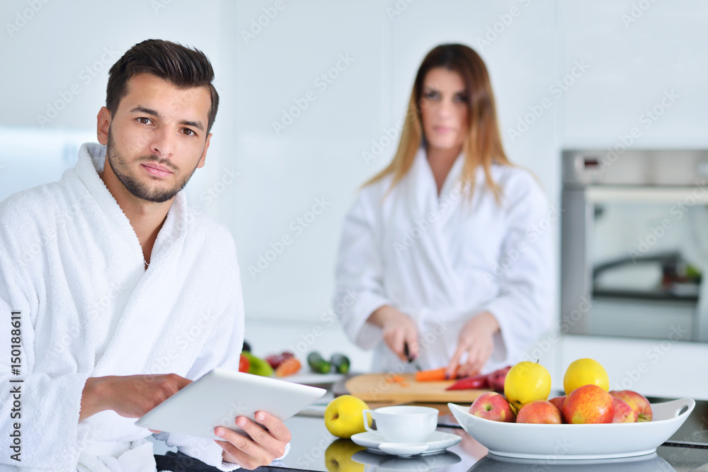 Happy couple cooking breakfast together in the kitchen Happy couple cooking breakfast together in the kitchen