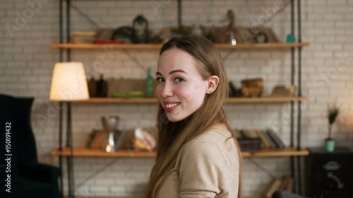 portrait of young cute and enamored woman with long blonde hair smile flirty and glancing with shy to the camera