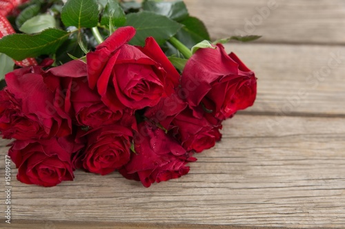 Bunch of red roses on wooden background