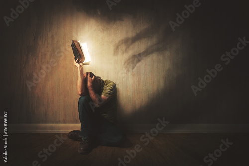 Fototapeta Bible and dark shadows