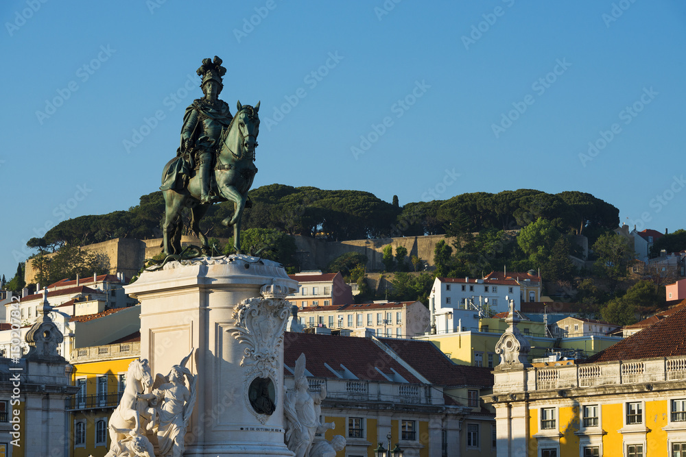 The Statue of the King Dom Jose in the Commerce Square (Praca do Comercio) with the Saint George Castle (Castelo de Sao Jorge) in the background, in Lisbon, Portugal