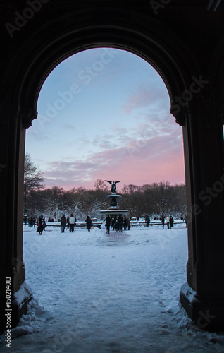 Silhouette entrance and fountain with sunset sky at Central Park