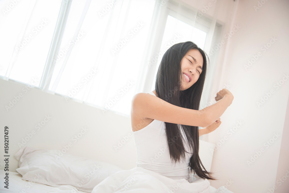 Beautiful Asian woman waking up on her bed in the morning. Beautiful Asian woman waking up on her bed in the morning.