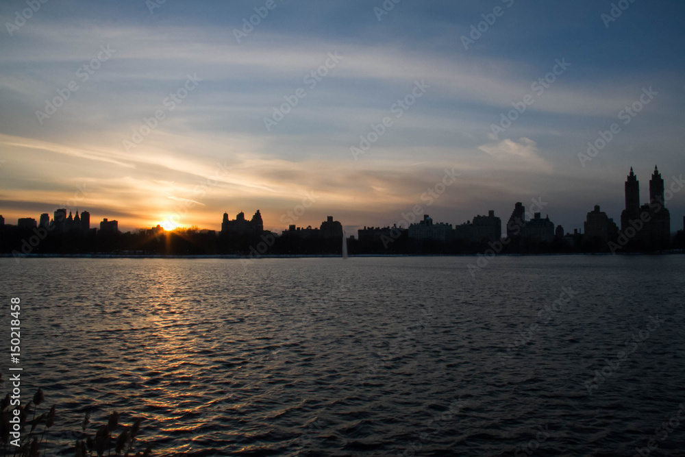 Sunset reflects on the lake in Manhattan city