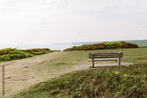 Bench on walkway with seaview