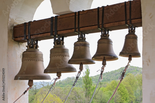 On top of Orthodox Christian monastery bell tower, Russia. Church bells hang in row