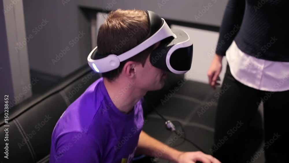 A man puts on a helmet of virtual reality. A man puts on a helmet of virtual reality.