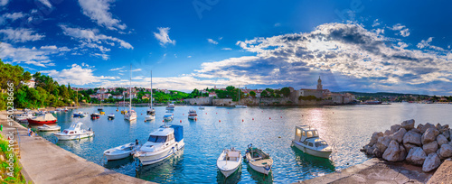 Wonderful romantic summer evening landscape panorama coastline Adriatic sea. Boats and yachts in harbor at cristal clear azure water. Old town of Krk on the island of Krk. Croatia. Europe. photo