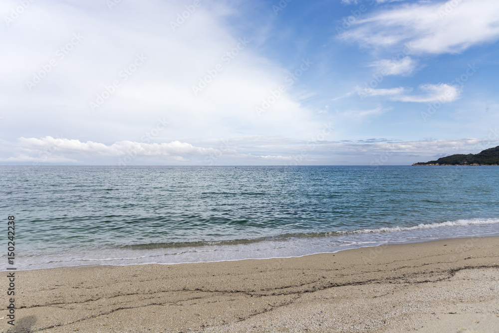 Landscape with sea view, waves, rocks and sea shells, clouds, photographed in Greece Landscape with sea view, waves, rocks and sea shells, clouds, photographed in Greece