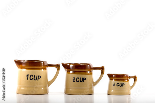 Antique measuring cups in three sizes