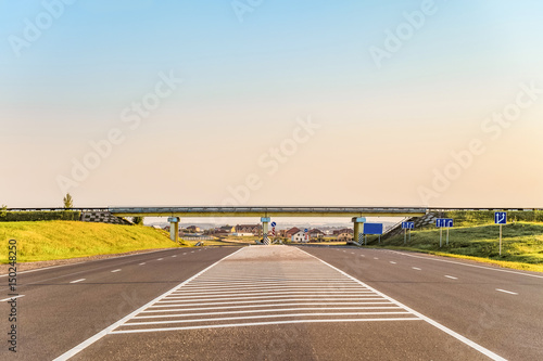 Multi-lane countryside asphalt road with marking. Intersection of the country roads on two levels. Disappearing into the distance perspective. Belgorod region, Russia. © nskyr2