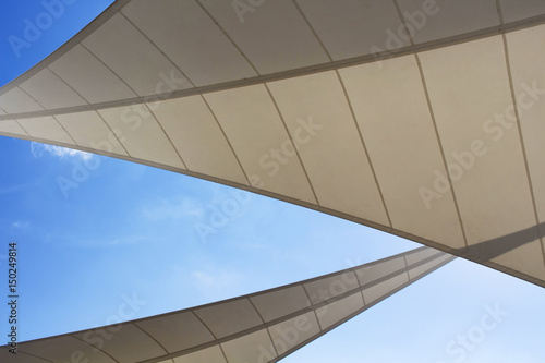 Bottom view of triangle shaped big sun shades and clear blue sky in the background in Bodrum which is Aegean coastal city of Turkey.