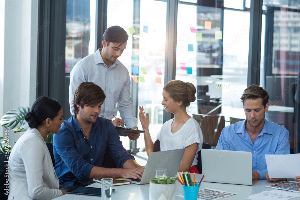 Team of graphic designers interacting with each other Team of graphic designers interacting with each other