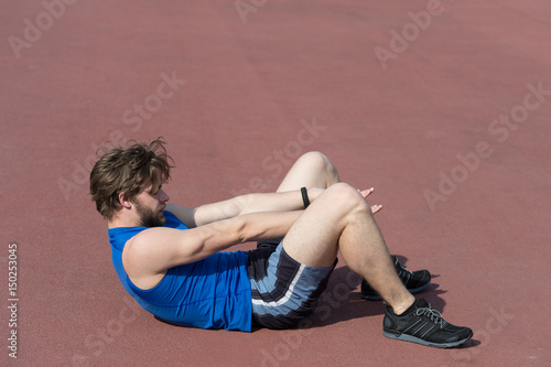 athletic bearded man with muscular body doing exercises for abdominal