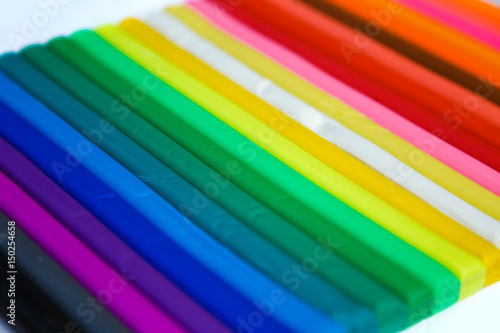 Set of plasticine palettes on white background. Rainbow colors