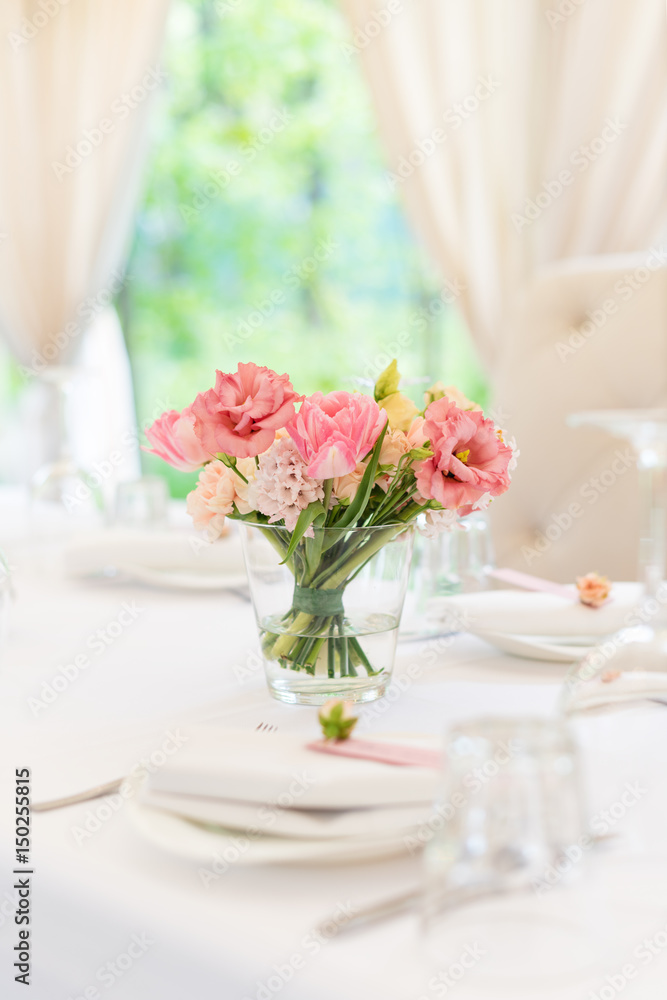 Flower table decorations for holidays and wedding dinner. Table set for holiday, event, party or wedding reception in outdoor restaurant. Flower table decorations for holidays and wedding dinner. Table set for holiday, event, party or wedding reception in outdoor restaurant.