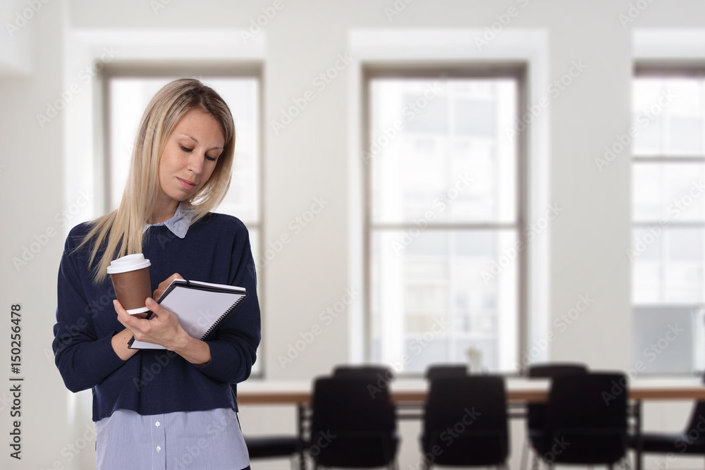 Portrait of young business woman preparing for the public speaking presentation in an office Portrait of young business woman preparing for the public speaking presentation in an office