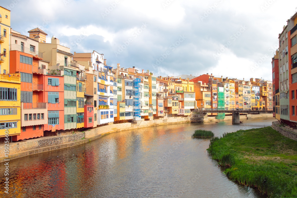 Typical colorful painted houses overlooking the river Onyar, Girona, Spain