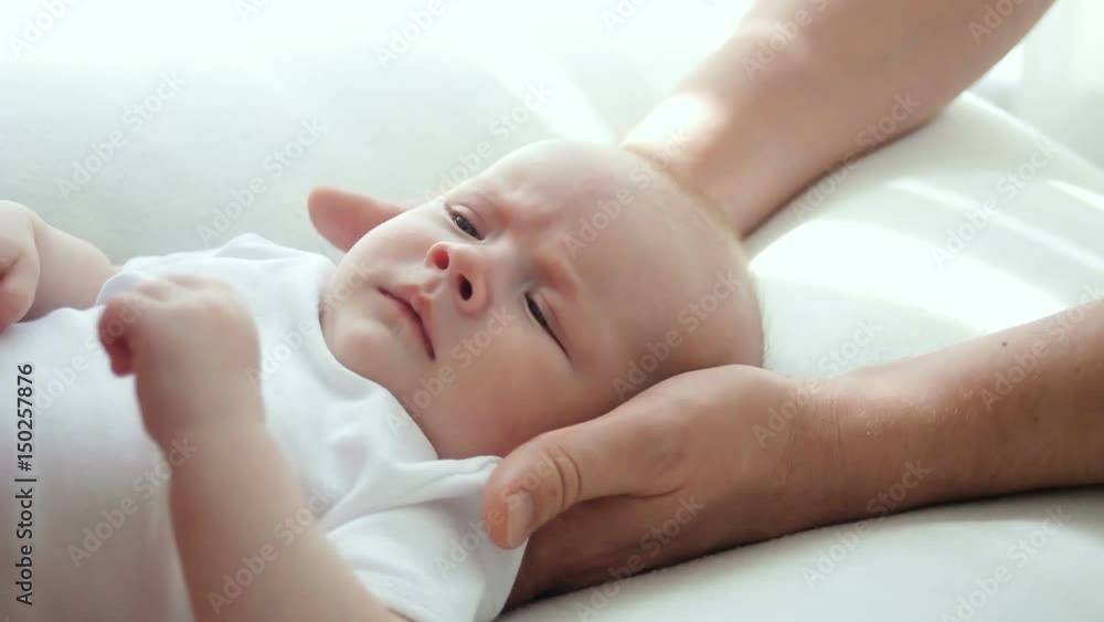 father kissing newborn son lying on the bed father kissing newborn son lying on the bed
