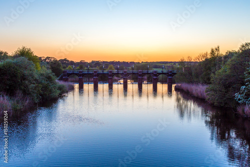 River weaver sluice gates Northwich Cheshire UK at sunset photo