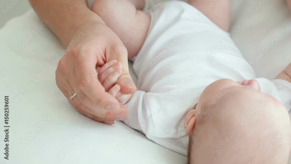father kissing newborn son lying on the bed father kissing newborn son lying on the bed