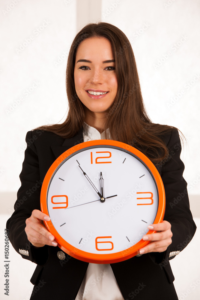 cute woman holding a clock as a symbol of time management cute woman holding a clock as a symbol of time management