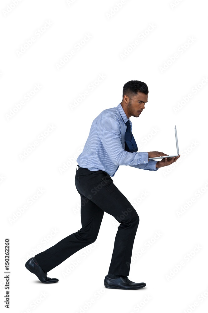 Businessman running while using laptop Businessman running while using laptop