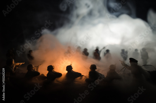 War Concept. Military silhouettes fighting scene on war fog sky background, World War Soldiers Silhouettes Below Cloudy Skyline At night. Attack scene. Armored vehicles