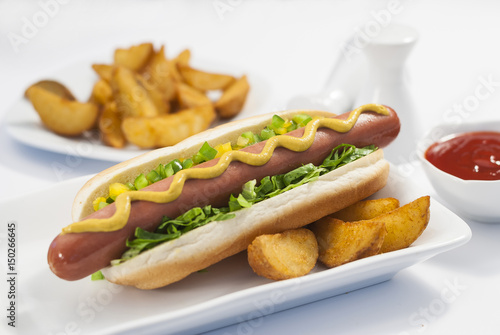 Chicken Jumbo Hotdog sandwich with fries & Ketchup on white plate 